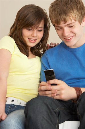 Teenage Couple Reading Text Message Stock Photo - Budget Royalty-Free & Subscription, Code: 400-05697207