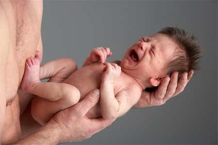 Crying Newborn Baby Held By Father Stock Photo - Budget Royalty-Free & Subscription, Code: 400-05697431