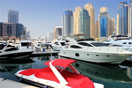 radodn (artist) - small speed red boat in yaght bay dubai Fotografie stock - Microstock e Abbonamento, Codice: 400-05698904