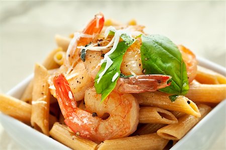 White square bowl of whole wheat penne pasta with sauteed shrimp and basil Stock Photo - Budget Royalty-Free & Subscription, Code: 400-05699200