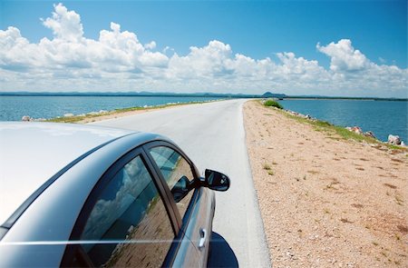 Car driving across ocean by the road Stock Photo - Budget Royalty-Free & Subscription, Code: 400-05699396