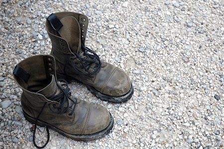 Old worn boots on a rocky floor Stock Photo - Budget Royalty-Free & Subscription, Code: 400-05690322