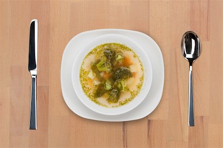 simsearch:400-09011310,k - A plate of Italian national meal - minestrone soup - with spoon and knife on a wooden table. Fotografie stock - Microstock e Abbonamento, Codice: 400-05690779