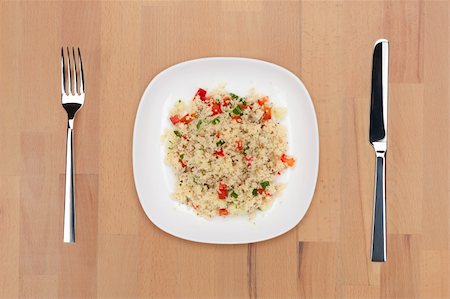 A plate of couscous with vegetables on a wooden table with fork and knife. Stock Photo - Budget Royalty-Free & Subscription, Code: 400-05690795