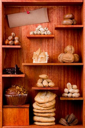 simsearch:400-04181279,k - Assortment of different nuts and foods with nuts in them in a wooden shelf. Add your text to the brown paper. Foto de stock - Super Valor sin royalties y Suscripción, Código: 400-05692108