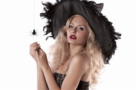 close up portrait of a young blonde girl dressed as a witch posing with a huge spider Stock Photo - Budget Royalty-Free & Subscription, Code: 400-05692644