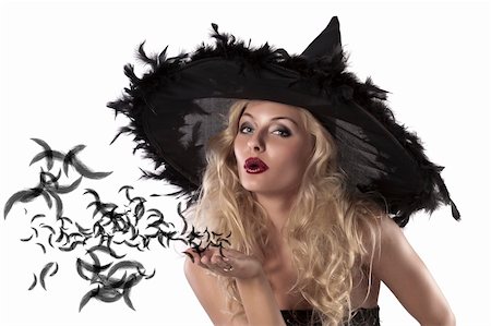 face shot of a cute and sexy girl dressed with a huge witch hat with feathers blowing a kiss Stock Photo - Budget Royalty-Free & Subscription, Code: 400-05692645