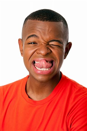 Young man with humorous funny expression sticking tongue out face, isolated. Stock Photo - Budget Royalty-Free & Subscription, Code: 400-05692721