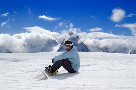 simsearch:400-04922906,k - Snowboarder resting on the ski slope. Caucasus Mountains, Dombay Stockbilder - Microstock & Abonnement, Bildnummer: 400-05692850