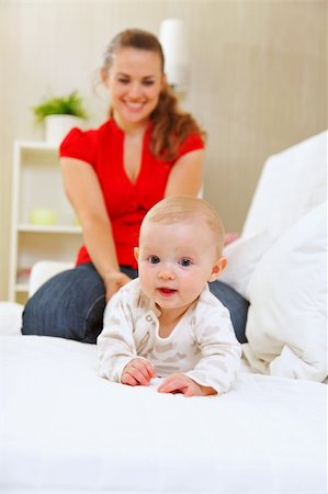 simsearch:400-05899075,k - Smiling mother and adorable baby playing on sofa Fotografie stock - Microstock e Abbonamento, Codice: 400-05692887