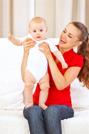 simsearch:400-05750410,k - Happy mothers helping little baby standing on her laps Photographie de stock - Aubaine LD & Abonnement, Code: 400-05692899