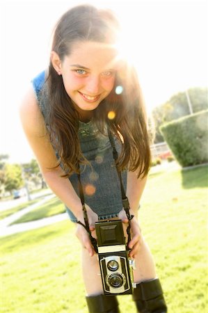 Beautiful Young Child Using a Vintage Camera to Shoot Film Fotografie stock - Microstock e Abbonamento, Codice: 400-05693308