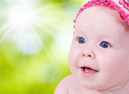 Cute beautiful little girl with pink flower on head looking up Stock Photo - Budget Royalty-Free & Subscription, Code: 400-05693645