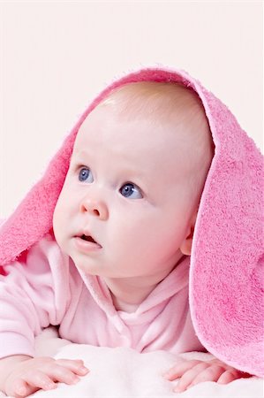 Happy seven month baby girl in pink towel Stock Photo - Budget Royalty-Free & Subscription, Code: 400-05693689