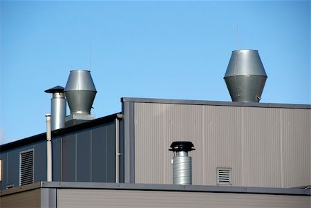 simsearch:622-06397846,k - Pipes of ventilation are located on a roof of a  building Photographie de stock - Aubaine LD & Abonnement, Code: 400-05693903