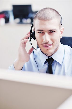 simsearch:400-03914864,k - businessman with a headset portrait at bright call center helpdesk support office Stock Photo - Budget Royalty-Free & Subscription, Code: 400-05704930