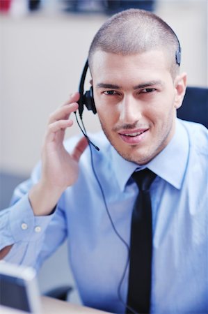simsearch:400-06108986,k - businessman with a headset portrait at bright call center helpdesk support office Stock Photo - Budget Royalty-Free & Subscription, Code: 400-05704931