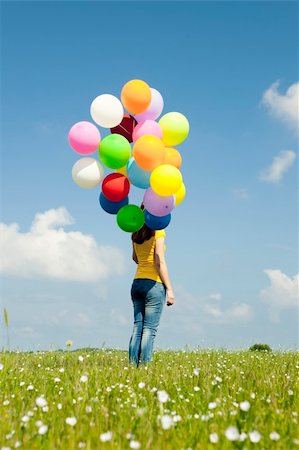 simsearch:400-06077546,k - Happy young woman with colorful balloons on a green meadow Stockbilder - Microstock & Abonnement, Bildnummer: 400-05705039