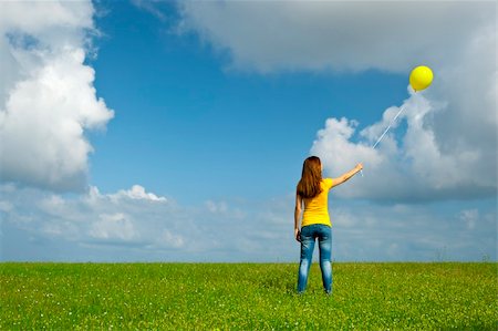 simsearch:400-06077546,k - Happy young woman with a yellow balloon on a green meadow Stockbilder - Microstock & Abonnement, Bildnummer: 400-05705031