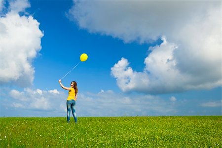 simsearch:400-06077546,k - Happy young woman with a yellow balloon on a green meadow Stockbilder - Microstock & Abonnement, Bildnummer: 400-05705032