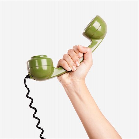 simsearch:400-05110035,k - Female hand holding a green handpiece from a vintage telephone Foto de stock - Royalty-Free Super Valor e Assinatura, Número: 400-05705044