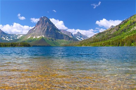 Mount Sinopah rises over Two Medicine Lake on a gorgeous summer day in Glacier National Park. Stockbilder - Microstock & Abonnement, Bildnummer: 400-05705142