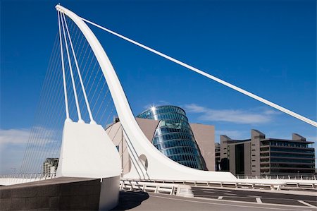 empty modern road - The Samuel Beckett Bridge is the newest bridge to cross the River Liffey in Dublin, Ireland. The modern structure is curved in the shape of a harp and uses cables, like a suspension bridge, to maintain the structure. Stock Photo - Budget Royalty-Free & Subscription, Code: 400-05705178
