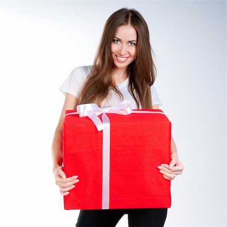 cute young girl with a gift on a white background Stock Photo - Budget Royalty-Free & Subscription, Code: 400-05705964