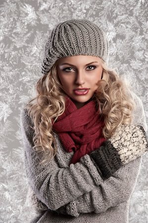 scarf curly woman - winter fashion shot of a beautiful girl with long curled blonde hair wearing a grey woolen cap, a grey sweater and warm gloves Stock Photo - Budget Royalty-Free & Subscription, Code: 400-05706022