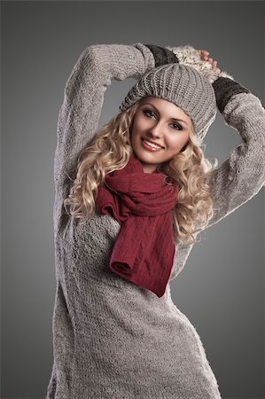 scarf curly woman - beautiful blonde curly girl in a winter fashion portrait wearing grey wool and a red scarf Stock Photo - Budget Royalty-Free & Subscription, Code: 400-05706023