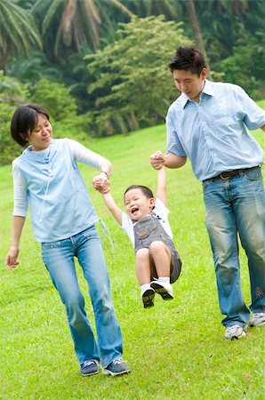 Happy Asian family walking in the park Stock Photo - Budget Royalty-Free & Subscription, Code: 400-05706246