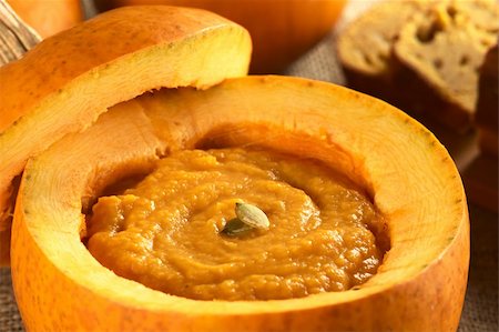 Fresh creamy pumpkin soup served in a pumpkin and garnished with pumpkin seeds (Selective Focus, Focus on the seeds) Stock Photo - Budget Royalty-Free & Subscription, Code: 400-05706807