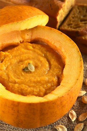 Fresh creamy pumpkin soup served in a pumpkin, garnished with pumpkin seeds (Selective Focus, Focus on the seeds) Stock Photo - Budget Royalty-Free & Subscription, Code: 400-05706808