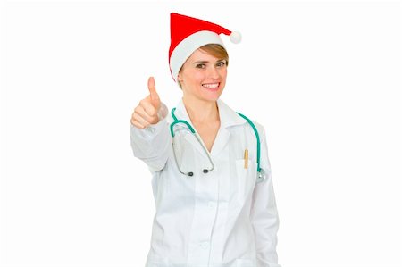 Smiling medical female doctor in Santa hat showing thumbs up isolated on white Stock Photo - Budget Royalty-Free & Subscription, Code: 400-05706959