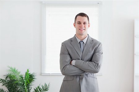 simsearch:400-06393704,k - Standing and smiling businessman with his arms folded Stock Photo - Budget Royalty-Free & Subscription, Code: 400-05709454