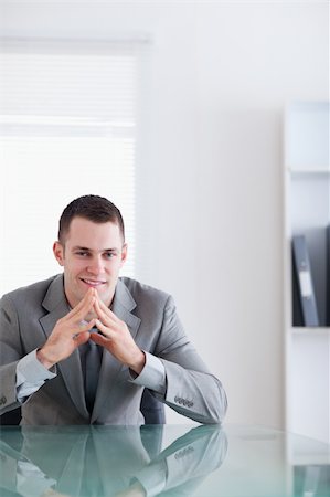 simsearch:400-05709450,k - Close up of young businessman sitting behind a table in a successful negotiation Foto de stock - Super Valor sin royalties y Suscripción, Código: 400-05709575