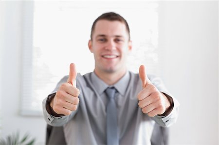 simsearch:400-05709450,k - Young and happy businessman giving thumbs up Foto de stock - Super Valor sin royalties y Suscripción, Código: 400-05709622