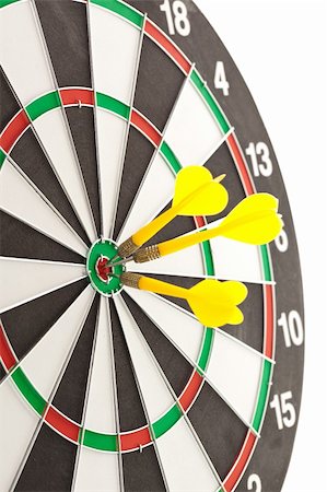 Three darts hitting the bullseye on a dartboard Stock Photo - Budget Royalty-Free & Subscription, Code: 400-05700929