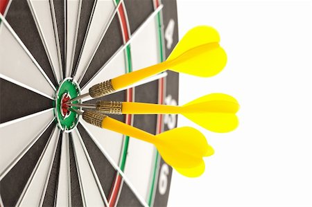 Three darts hitting the bullseye on a dartboard Stock Photo - Budget Royalty-Free & Subscription, Code: 400-05700933