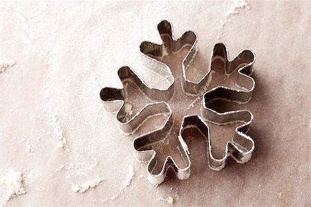 Close-up of a snowflake gingerbread cutter with flour. Stock Photo - Budget Royalty-Free & Subscription, Code: 400-05701350