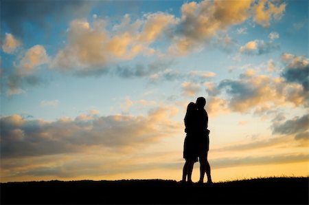 Silhouette young couple  at sunset Stock Photo - Budget Royalty-Free & Subscription, Code: 400-05701428