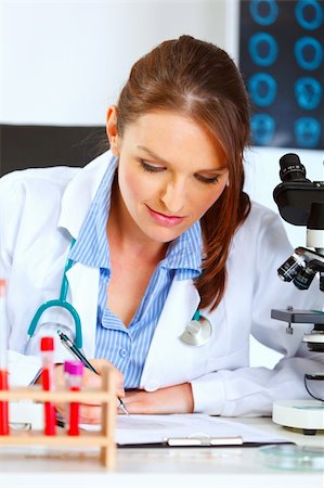 simsearch:400-07099889,k - Female medical doctor working at her office Stock Photo - Budget Royalty-Free & Subscription, Code: 400-05701719