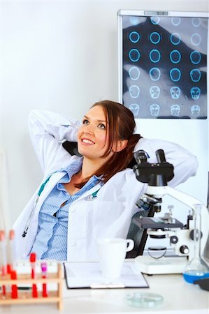 simsearch:400-04925813,k - Medical doctor woman sitting at office table and relaxing Stock Photo - Budget Royalty-Free & Subscription, Code: 400-05701713