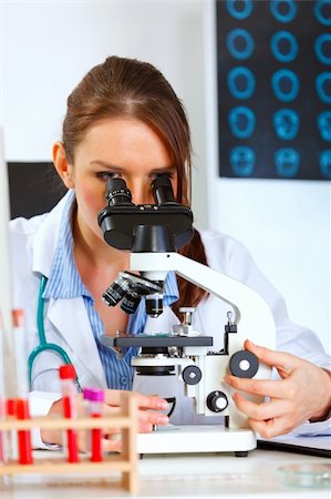 simsearch:400-07099889,k - Female doctor using microscope in medical laboratory Stock Photo - Budget Royalty-Free & Subscription, Code: 400-05701721