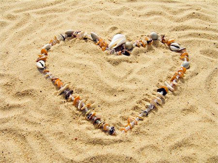 Heart from cockleshells and sea pebbles laid out on sand Stock Photo - Budget Royalty-Free & Subscription, Code: 400-05701963