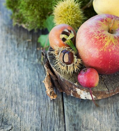 pear with leaves - Autumn series. Nature background made of autumn fruit in the forest and beautiful sunlight in the back. Chestnut, vine leaf, wild apple, quince and apples. Stock Photo - Budget Royalty-Free & Subscription, Code: 400-05702018