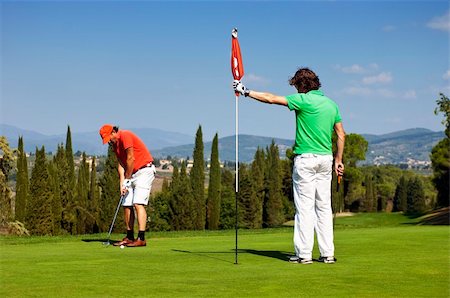 Flight of two golfers playing on the green of a golf course Photographie de stock - Aubaine LD & Abonnement, Code: 400-05702842