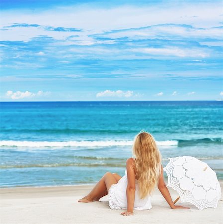 Woman with umbrella on the tropical beach Fotografie stock - Microstock e Abbonamento, Codice: 400-05703158
