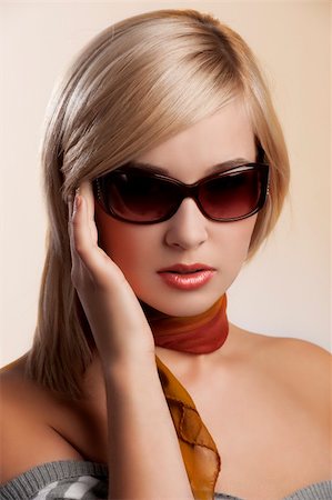 blond and beautiful young woman in a fashion portrait wearing sunglasses jumper and an autumn scarf Stock Photo - Budget Royalty-Free & Subscription, Code: 400-05703257