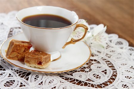 Cookies and coffee with flower on wooden background decorated with white lace napkin Stock Photo - Budget Royalty-Free & Subscription, Code: 400-05703708